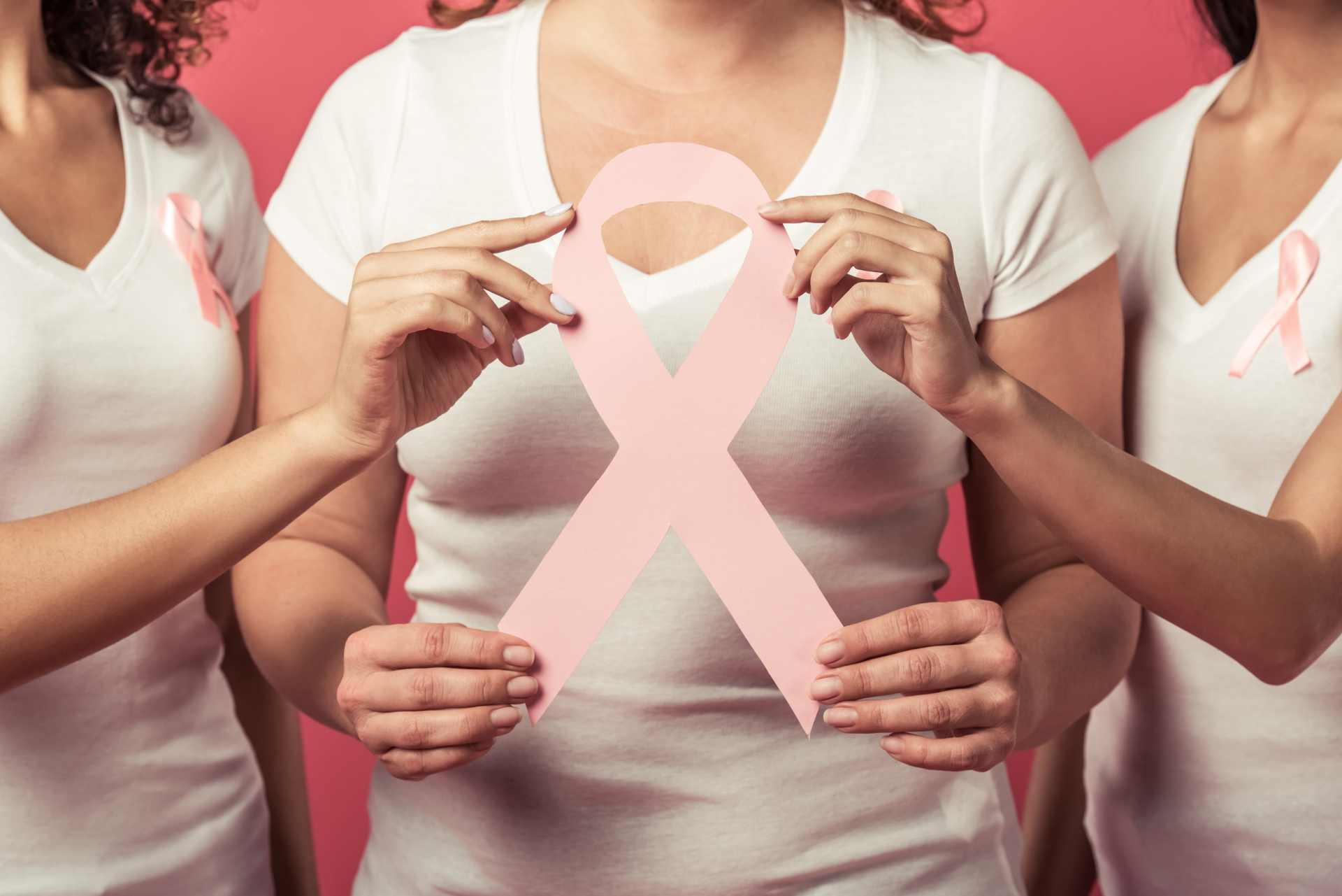 Women against breast cancer wearing pink ribbons.