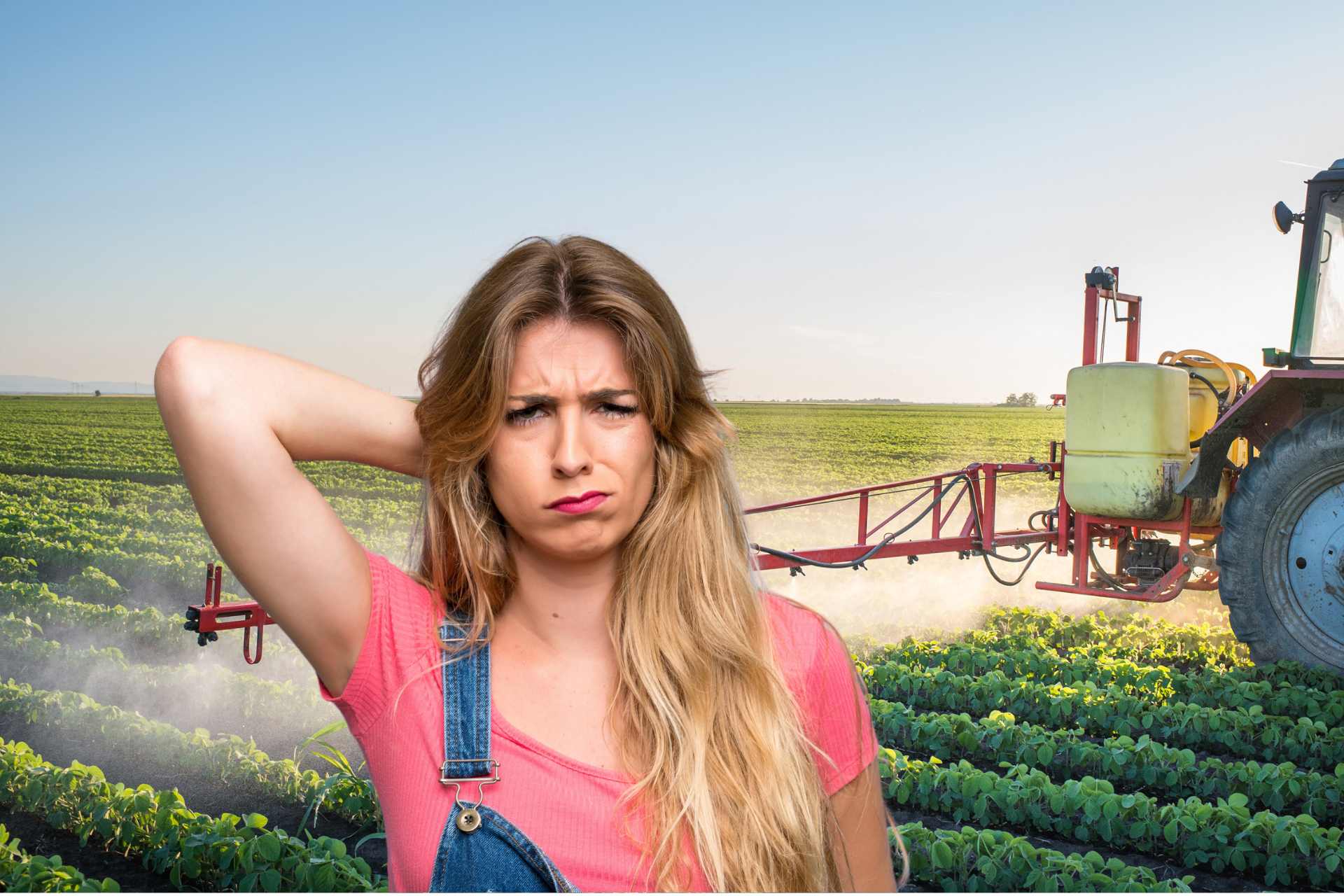 A woman in overalls as a tractor sprays Glyphosate in the background.