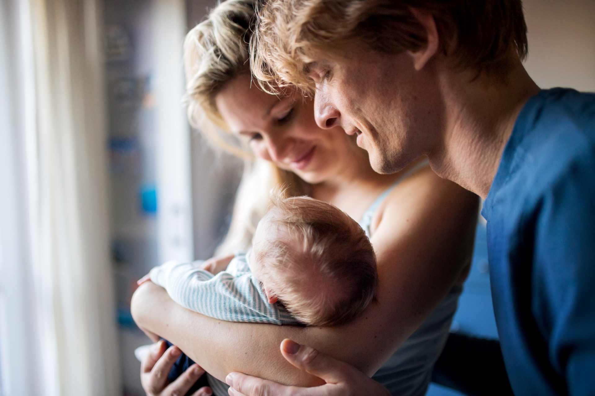 A young couple with their new born baby.