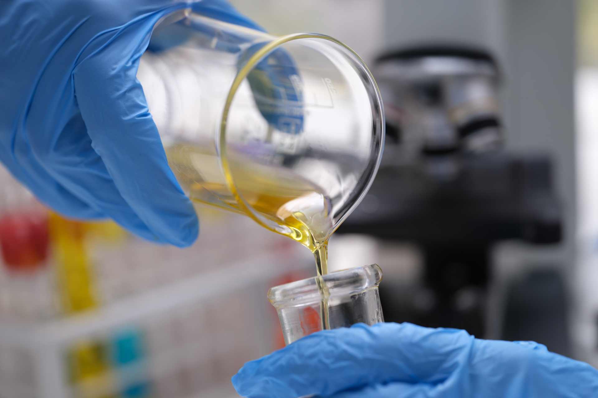 Liquified honey being poured into a glass tube for testing.