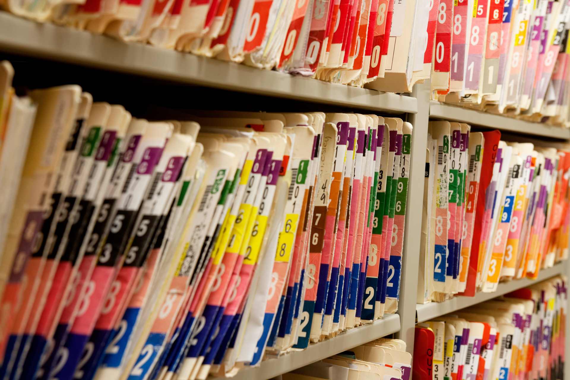 A row of medical files on a shelf, suggesting patient records or injury claims.