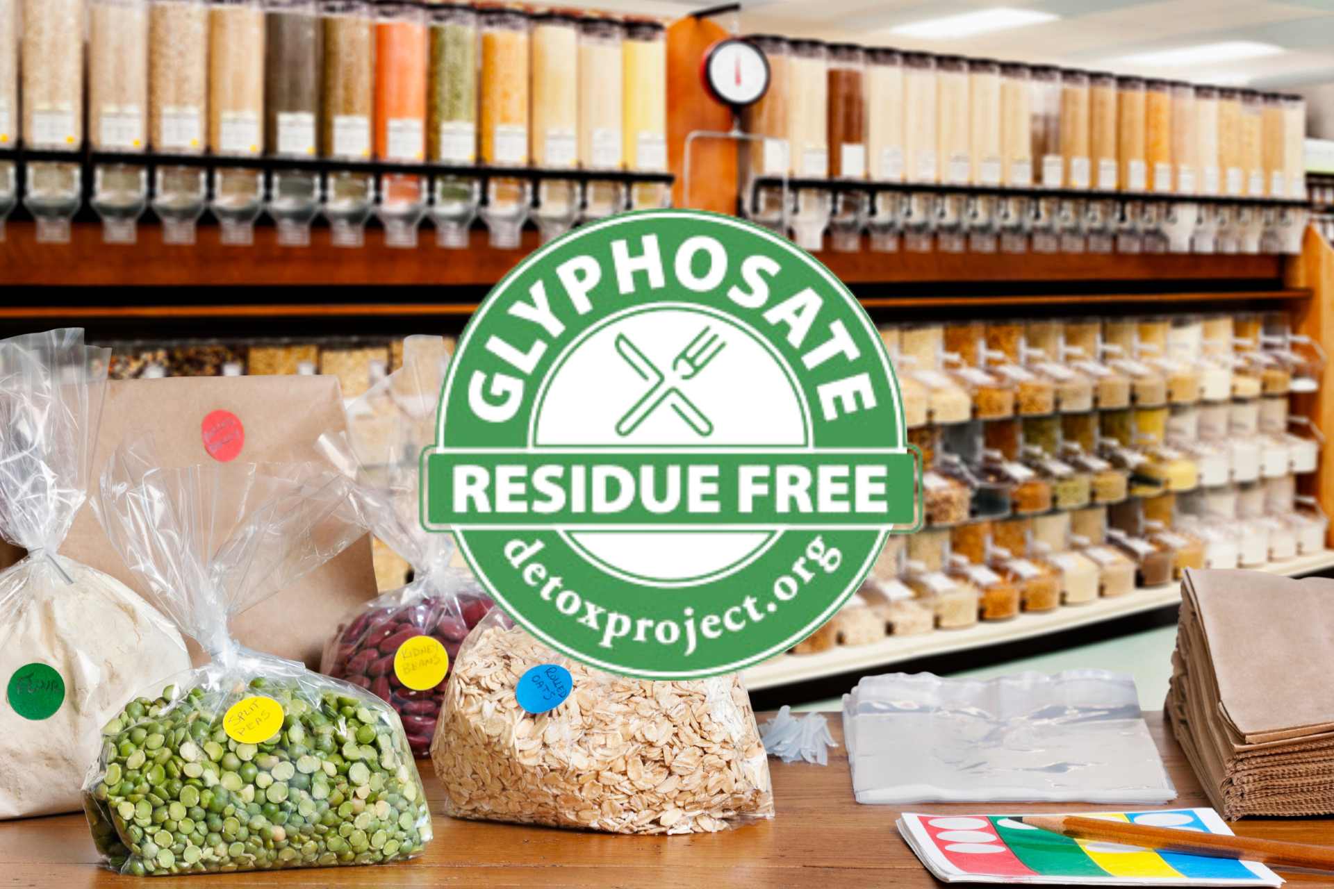 Assorted dry foods including spices, dried herbs, lentils, and peas displayed in glass jars —representing everyday pantry staples potentially affected by glyphosate residues.