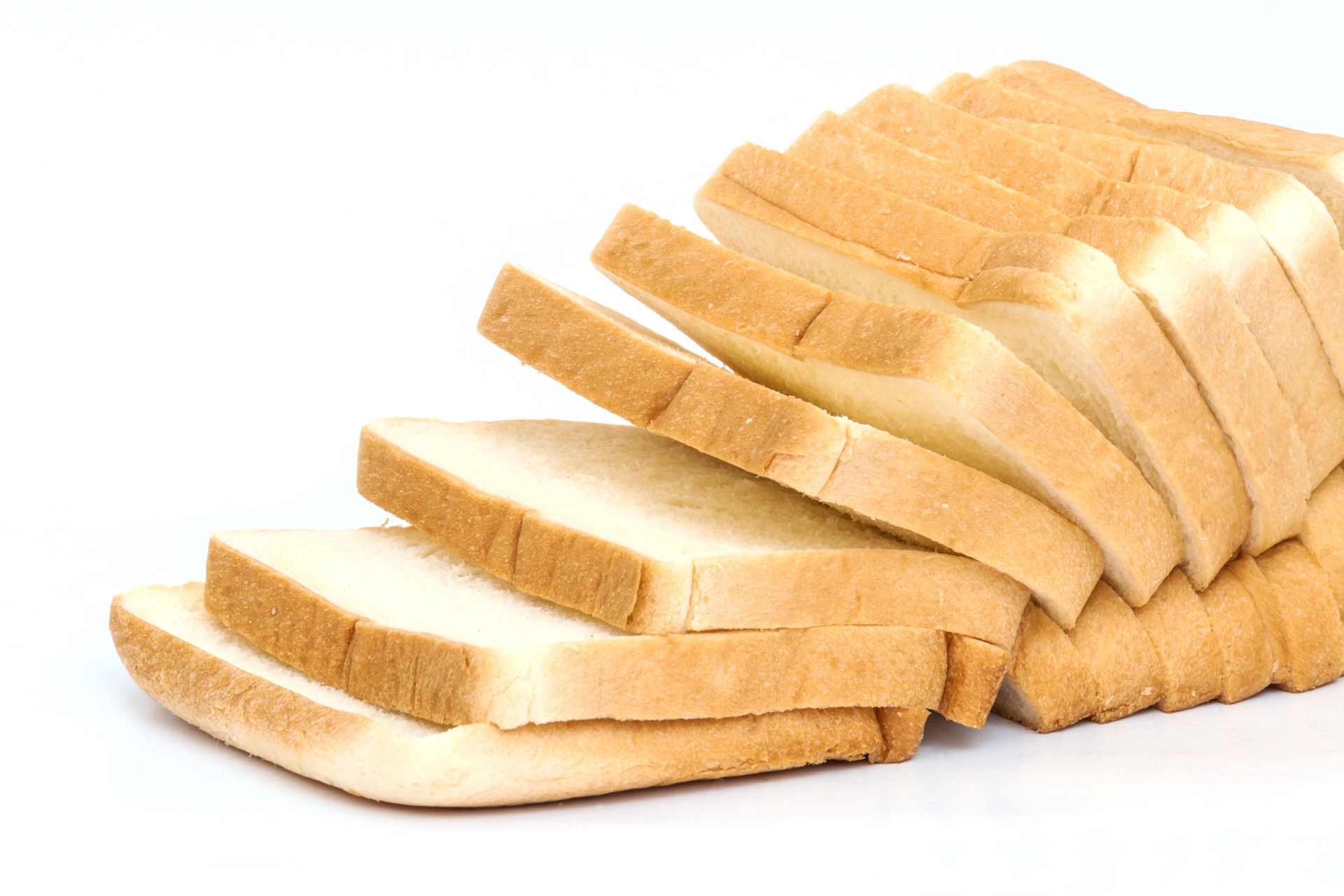 Sliced white bread arranged on a white background, symbolizing common supermarket loaves tested for glyphosate residues.