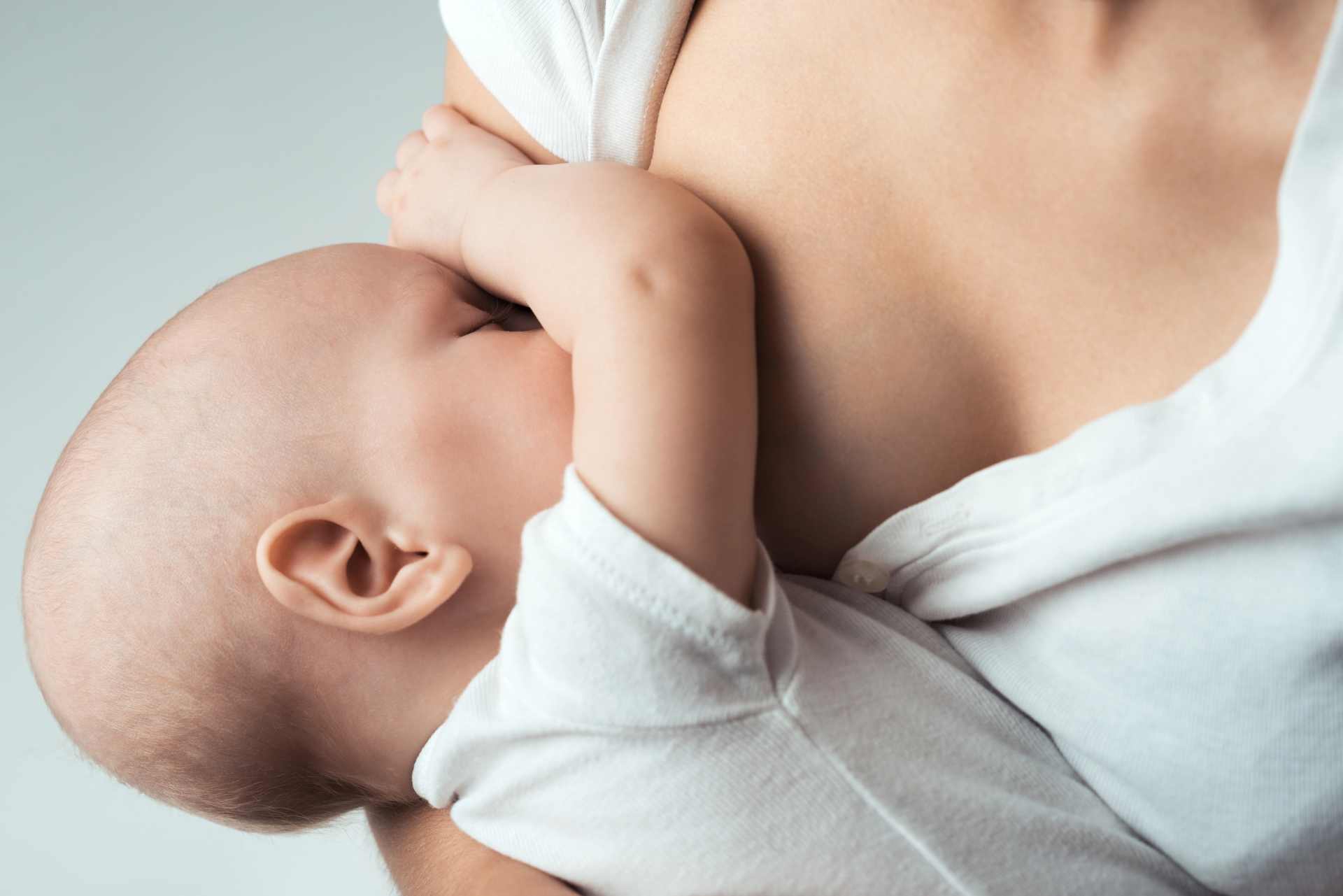 Infant breastfeeding from mother — symbolizing the natural bond and raising awareness about chemical exposure through breast milk.