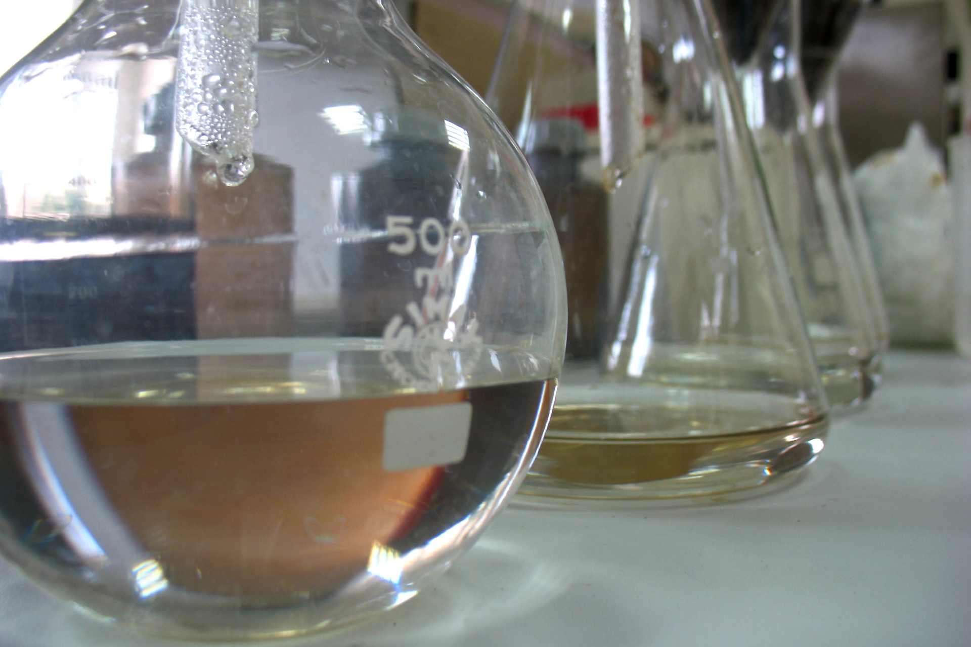 Laboratory glassware and testing equipment symbolising chemical analysis — highlighting the lack of testing on full herbicide formulations.