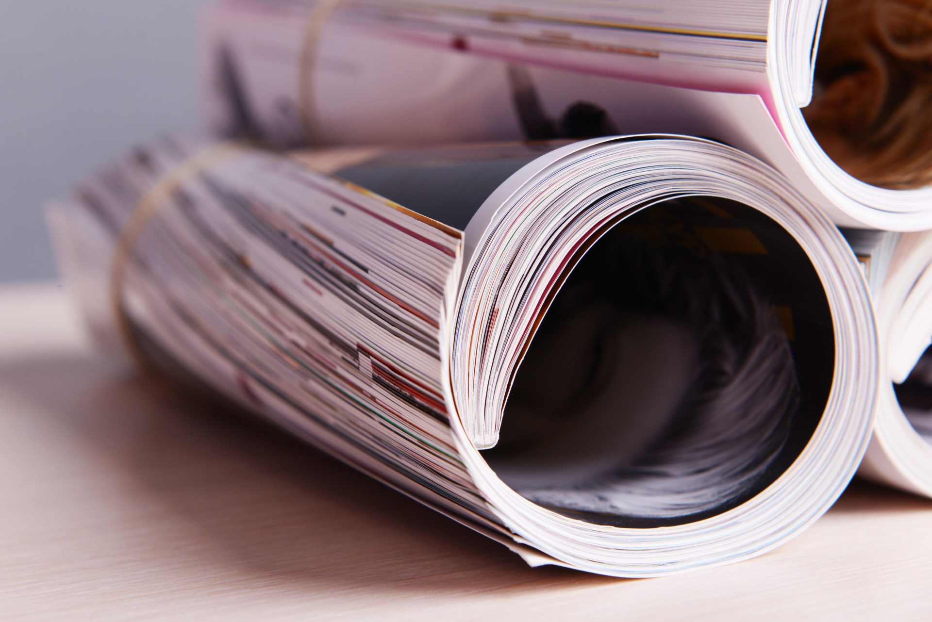 Rolled-up magazines on a table, suggesting the role of media in shaping glyphosate-related narratives.