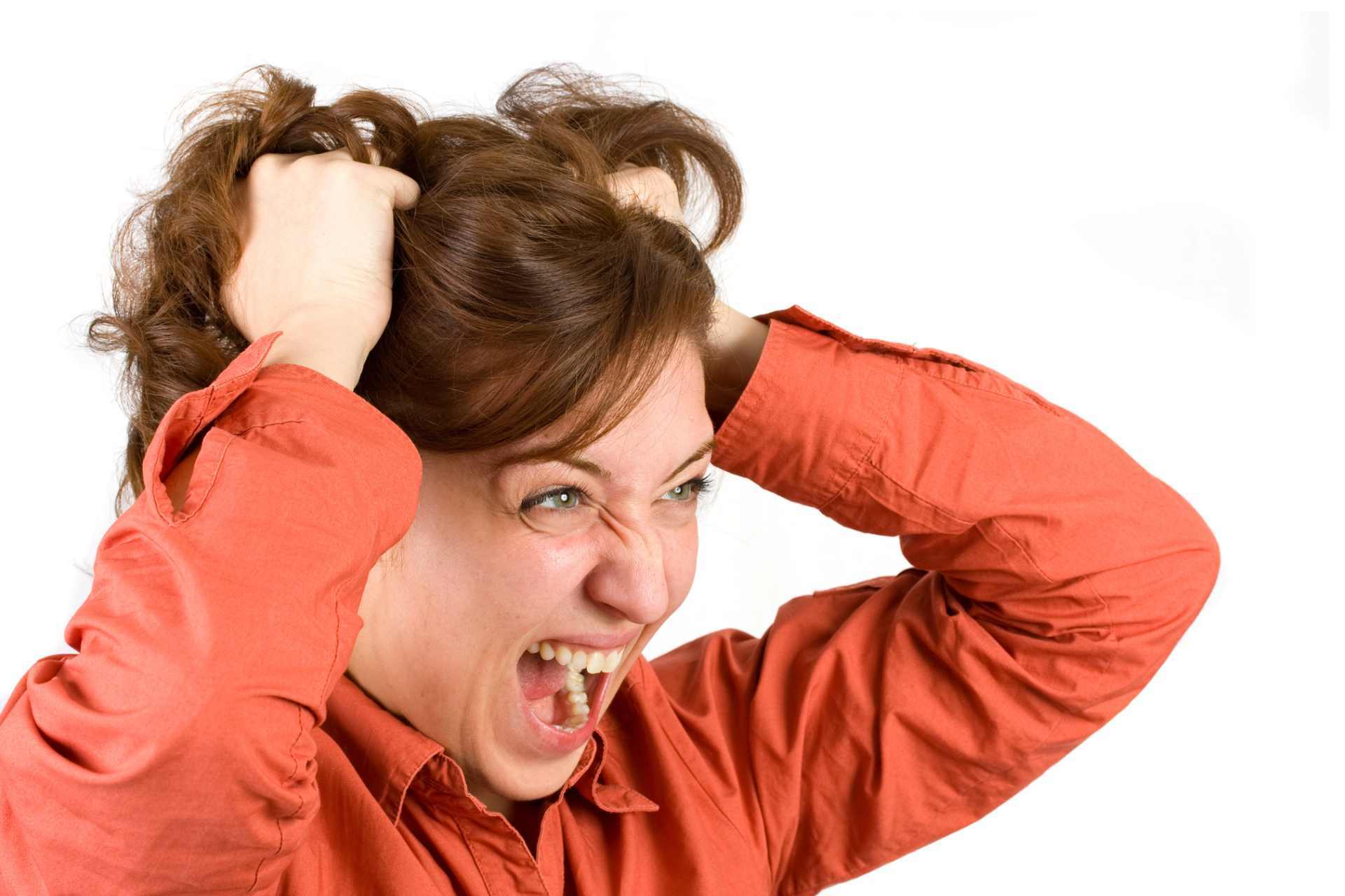 A frustrated woman clutching her hair, symbolising hormonal imbalance or disrupted endocrine function.