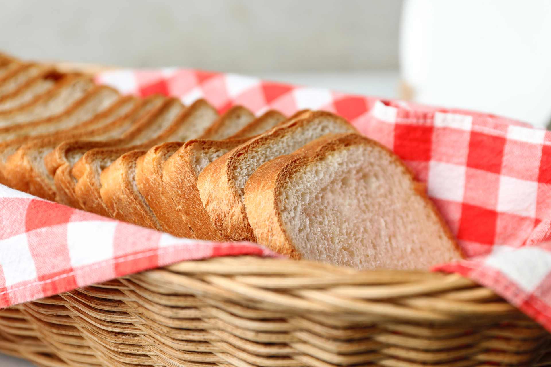 Slices of fresh bread in a basket, representing staple foods where glyphosate residues have been detected