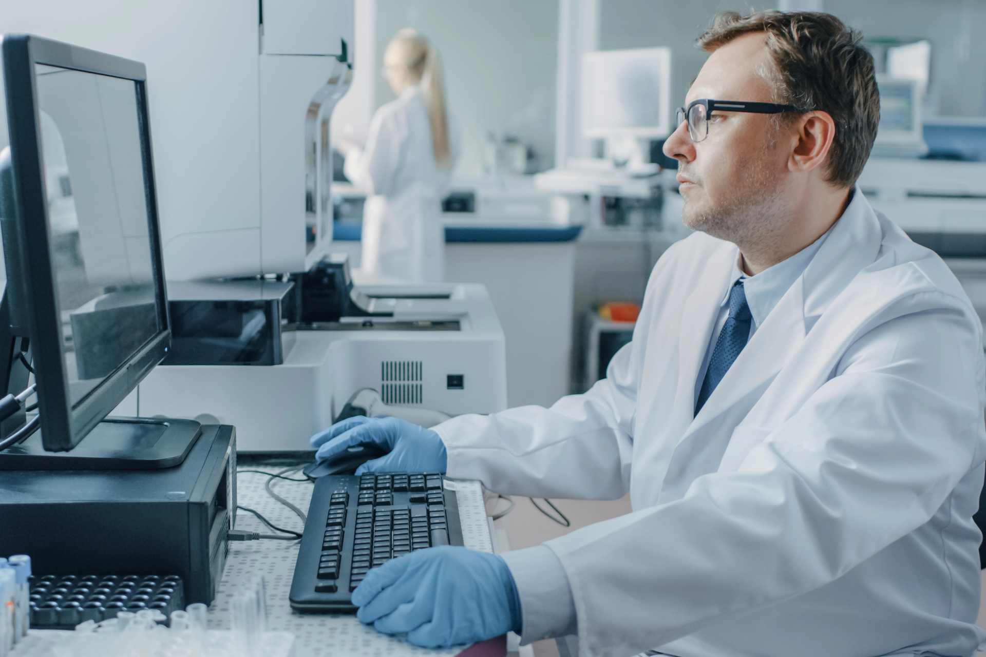 Male research scientist reviewing food residue analysis data in a laboratory while investigating glyphosate and chemical testing methods for food safety assessment