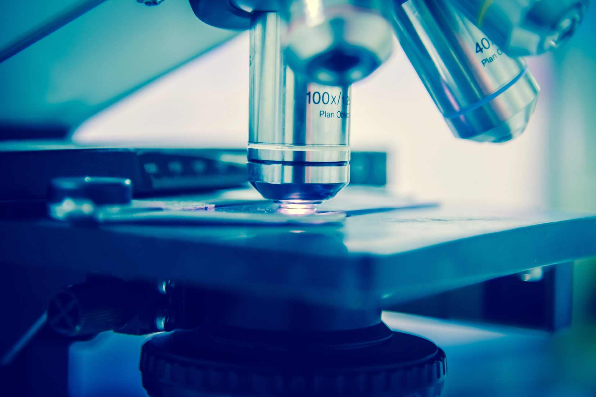 Close-up of a laboratory microscope used in scientific research exploring metabolomics, chronic chemical exposure, and the body’s biological response to environmental stress.