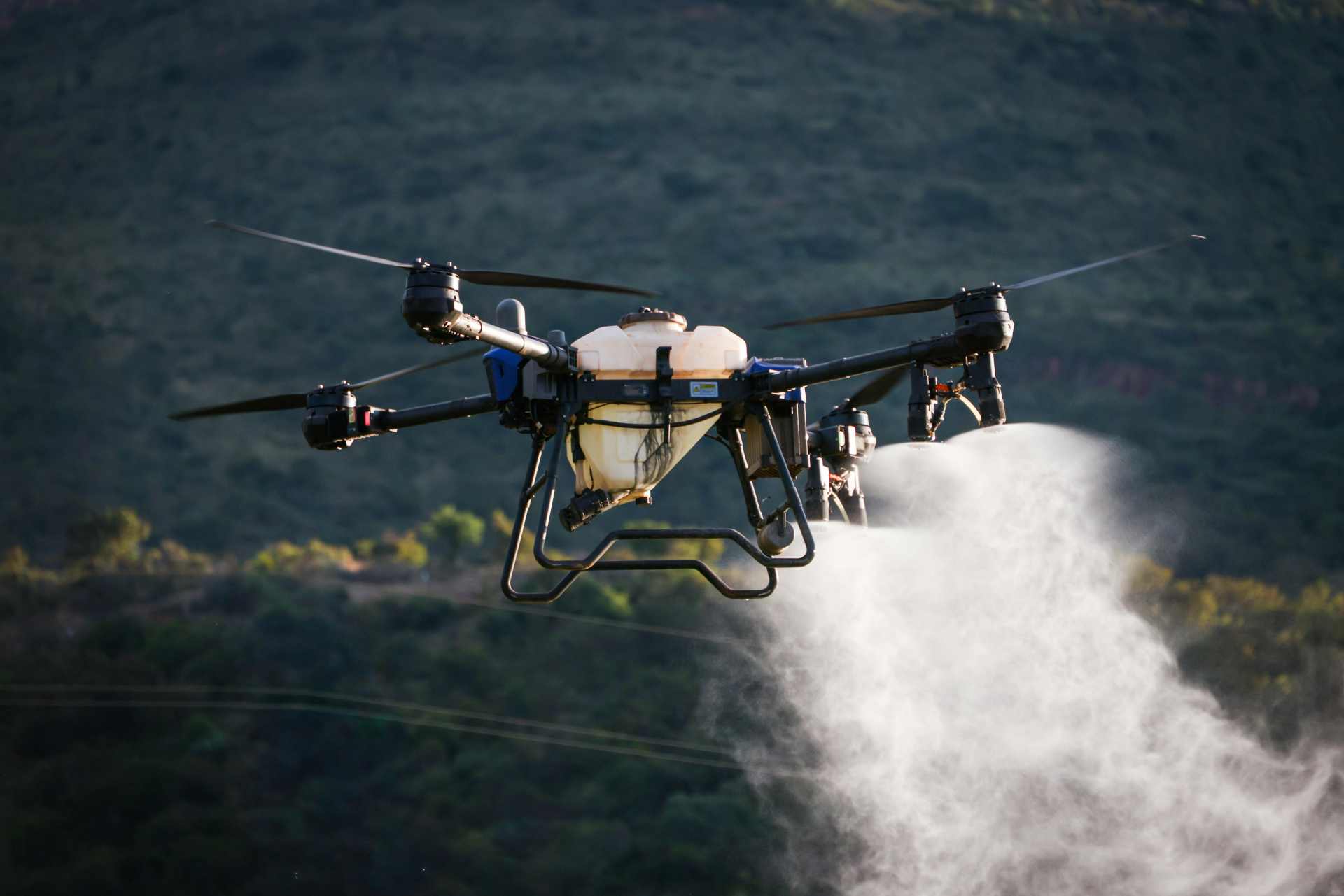 Close-up of an agricultural drone spraying herbicide over farmland, representing precision agriculture, AI-guided farming technology, and modern chemical-dependent farming systems.
