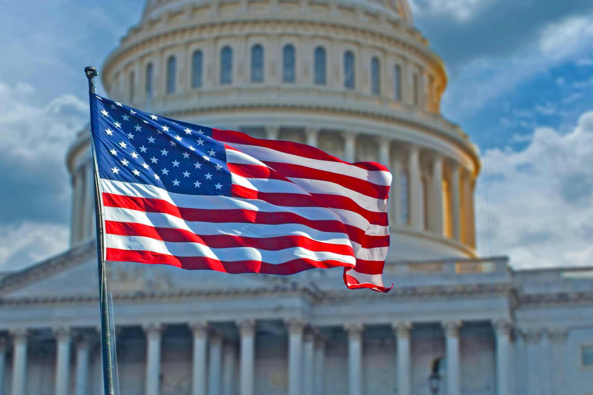 The United States Supreme Court building with an American flag, representing the Court's ruling on Monsanto's Roundup warning label lawsuit.