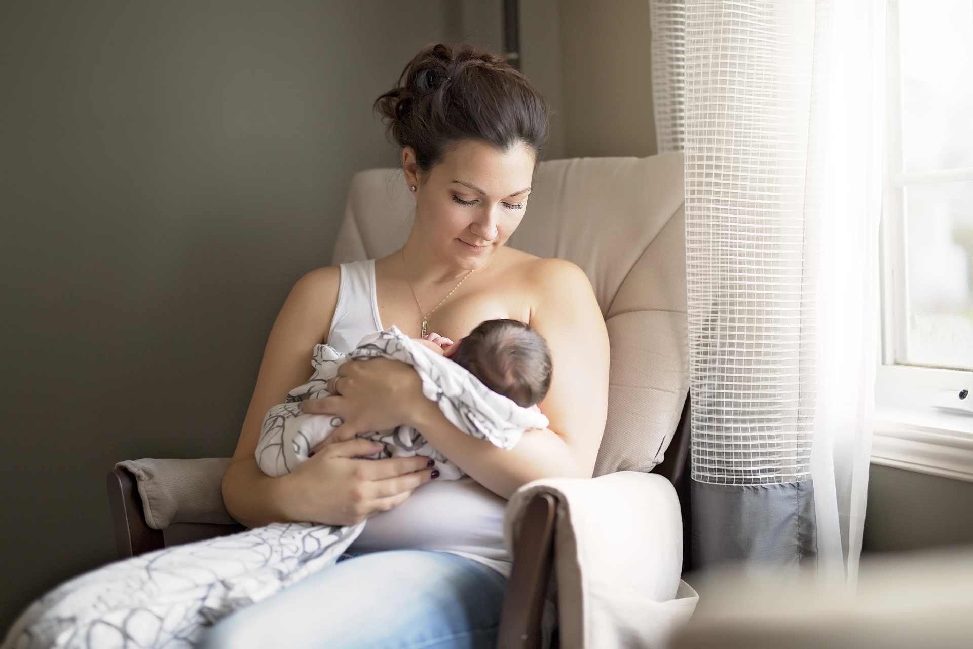 Mother breastfeeding her young son, accompanying an article examining research into glyphosate in human breastmilk.